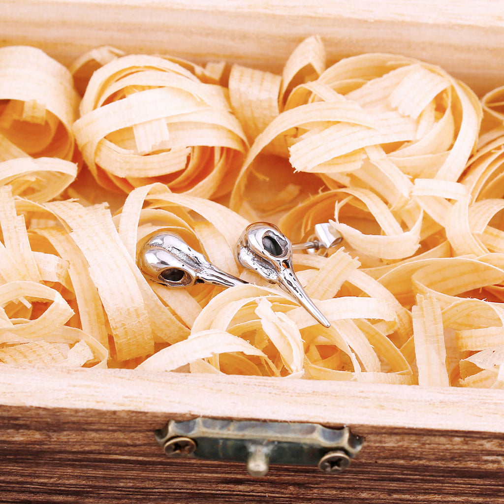 Mindre ear studs avbildande fågelskallar