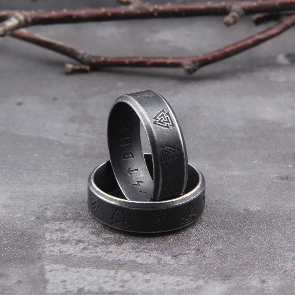 Mörkgrå vikingaring med valknutsymboler på utsidan och den 24-typiga runraden på insidan
