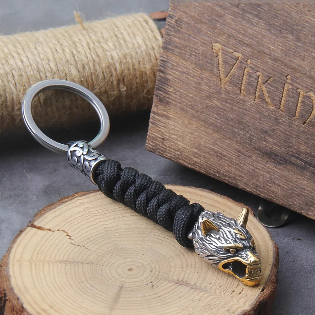 Svart paracord nyckelband med guld- och stålfärgad ulv