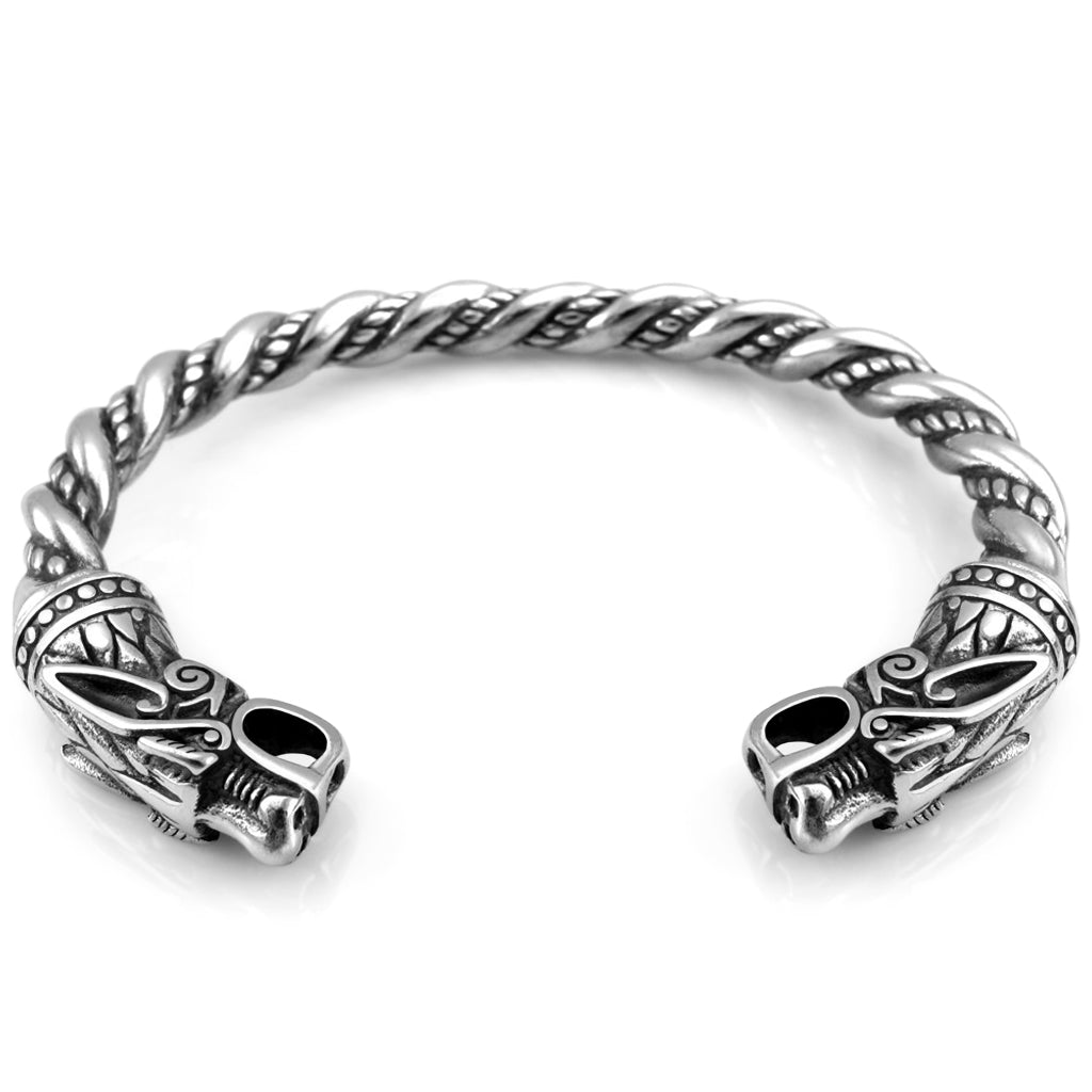 Viking armring utsmyckad med varghuvuden i ändarna