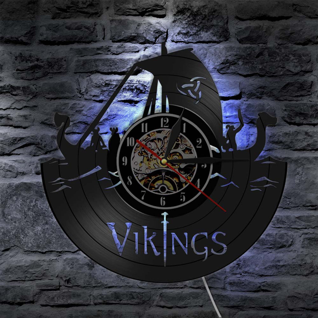 Bakgrundsbelyst väggur med utmejslat motiv av vikingaskepp och krigare