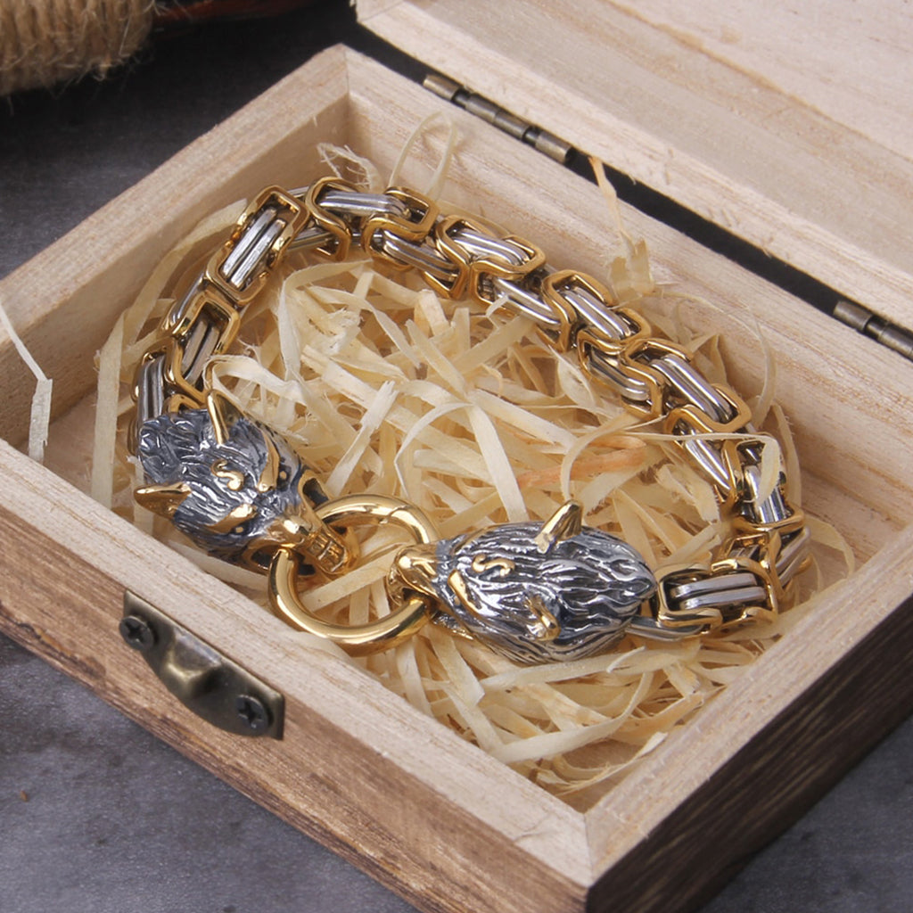 Stål- och guldfärgad kejsarlänk med låsanordning som består av två varghuvuden hållande ring mellan tänderna
