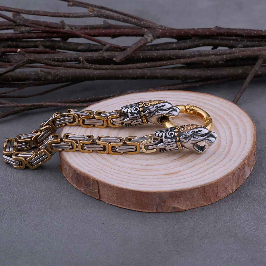 Silver- och guldfärgat kejsarlänk-armband dekorerat med snidade kattdjur