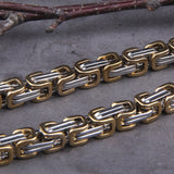 Kungslänk-armband tillverkat i silver- och guldfärgat stål